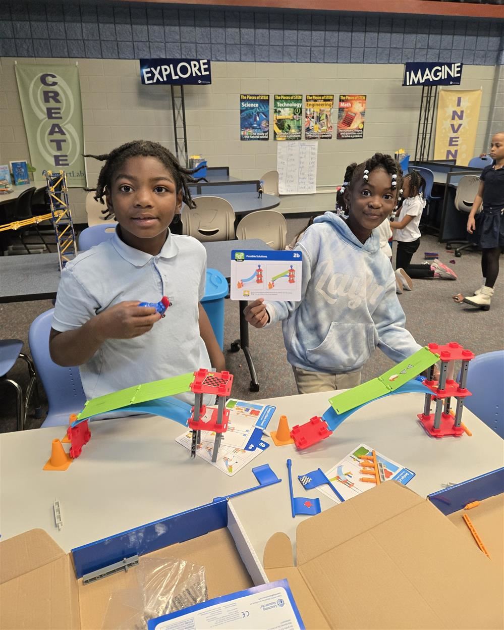  two students building in STEM class